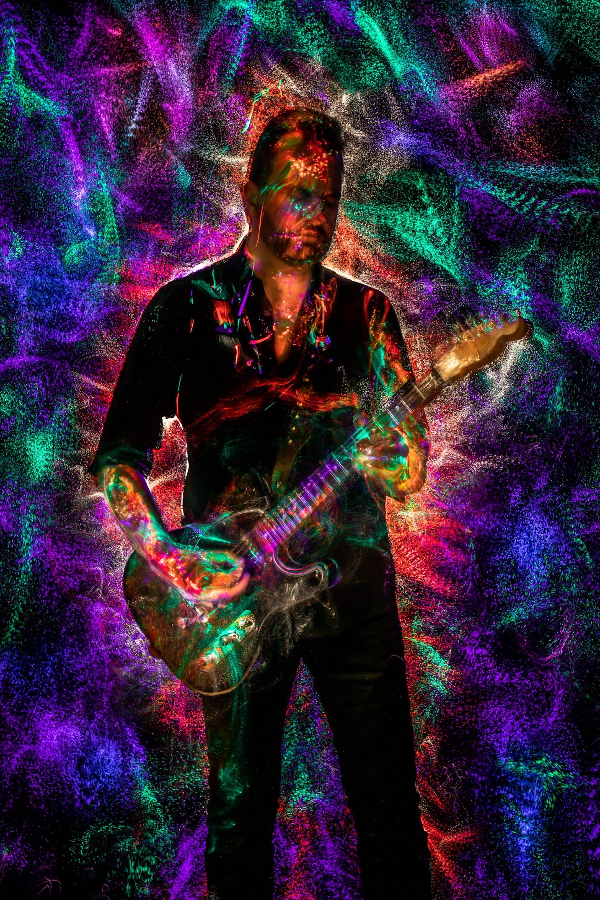 Ray Neyens performing with an electric guitar, from his official artist website